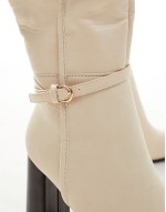 knee high buckle boots in cream